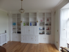 Built in bookcase in MDF painted white.  Also note window shutters and radiator cover.