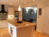 Framed painted wood kitchen. Granit work tops with Oak on island. Note lighting options and feature wall.